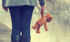 Lonely woman with teddy bear